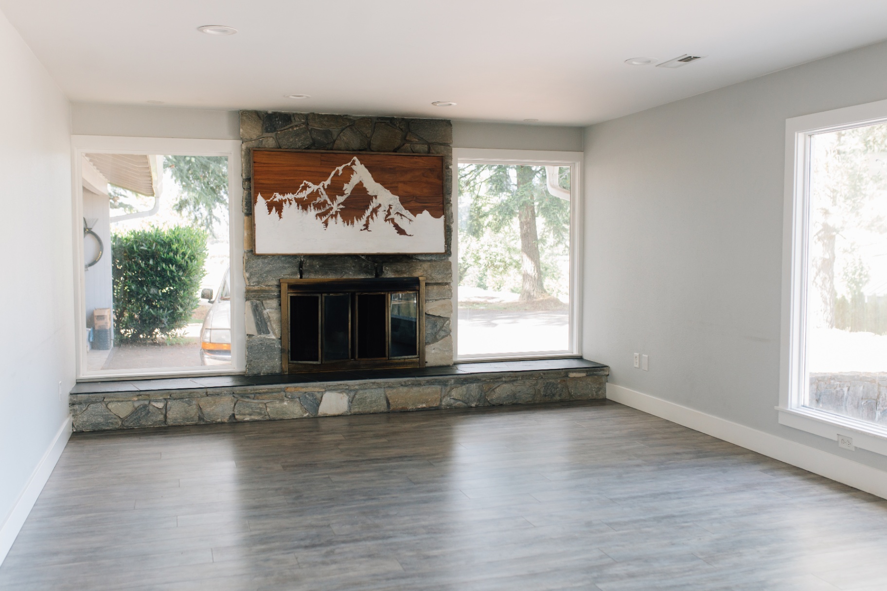 Upstairs living room with stone fireplace and large windows