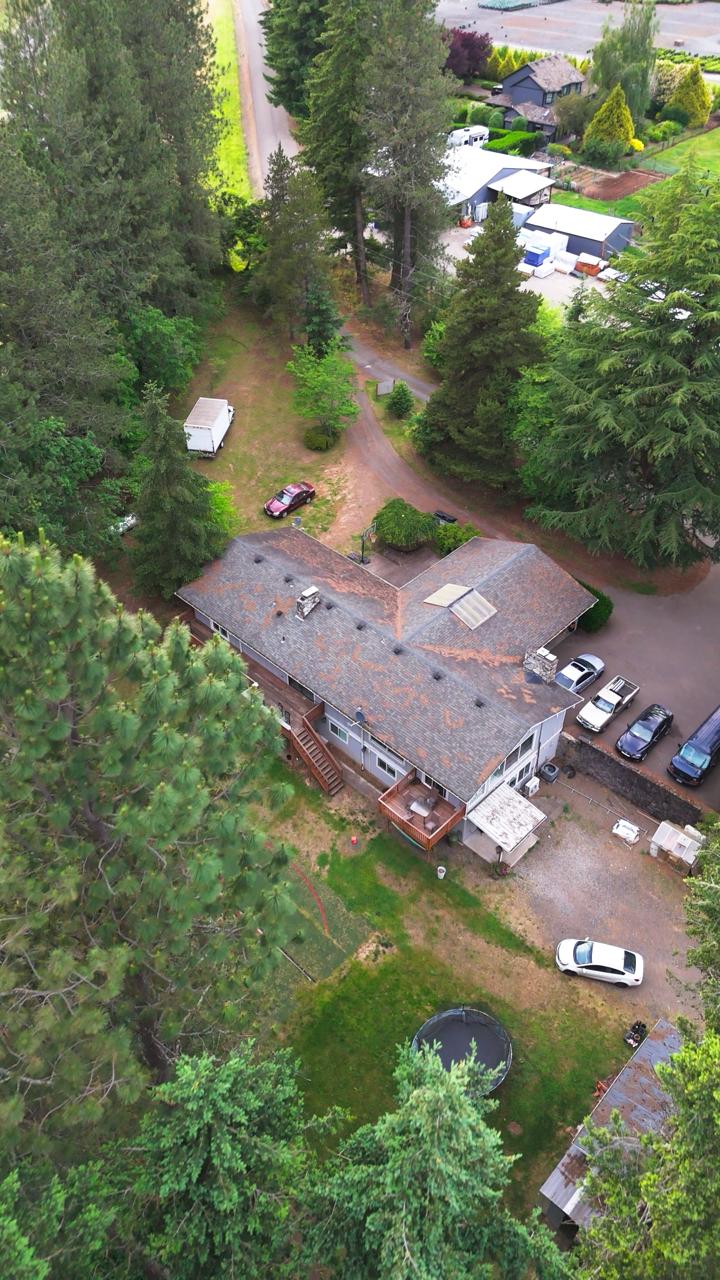 Aerial view of the GCMS men's residence surrounded by tall evergreens