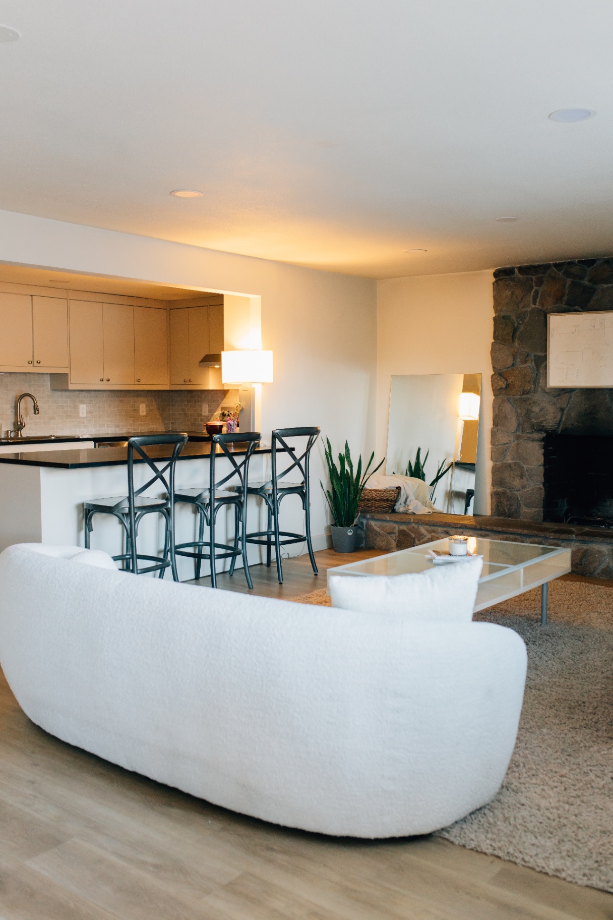 Open living and kitchen area with stone fireplace